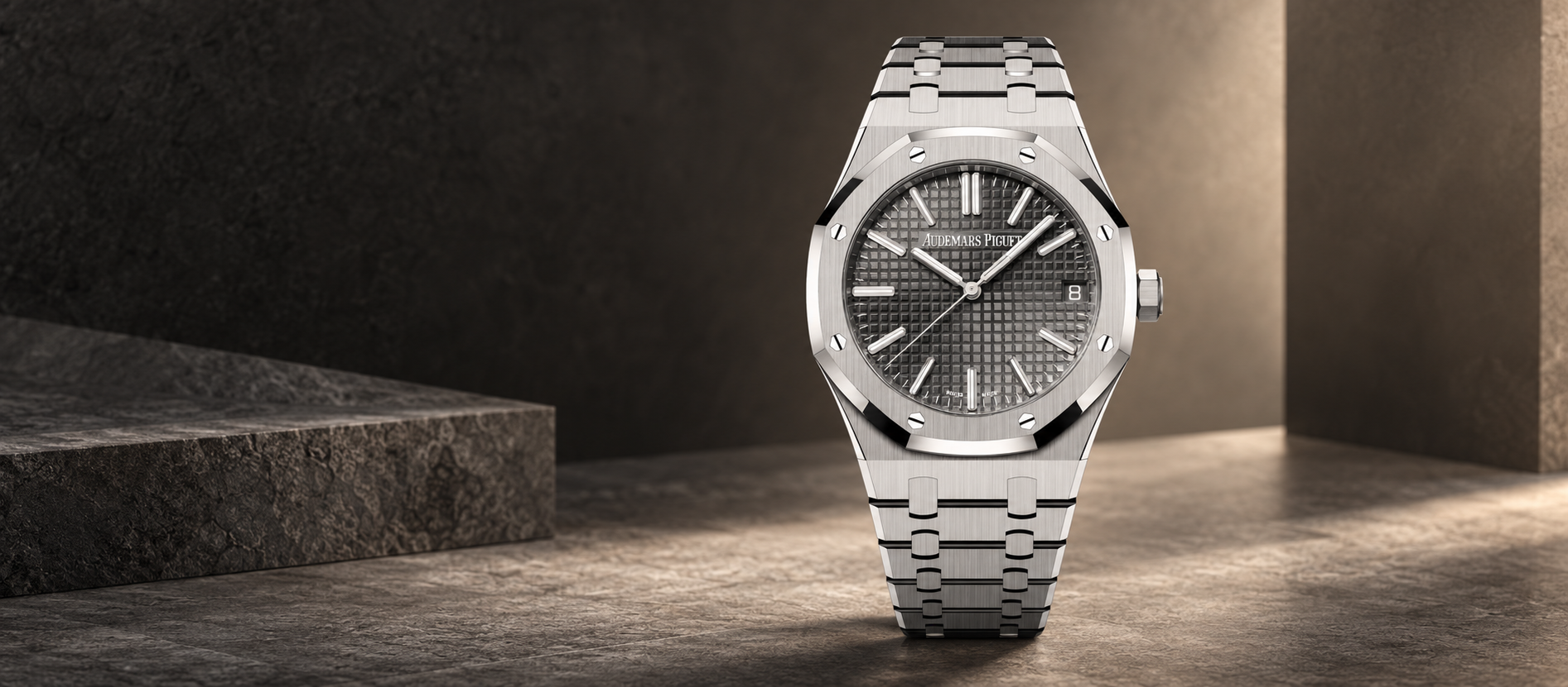 Audemars Piguet Royal Oak 15510ST with grey Grande Tapisserie dial and stainless steel integrated bracelet against a charcoal and taupe stone background