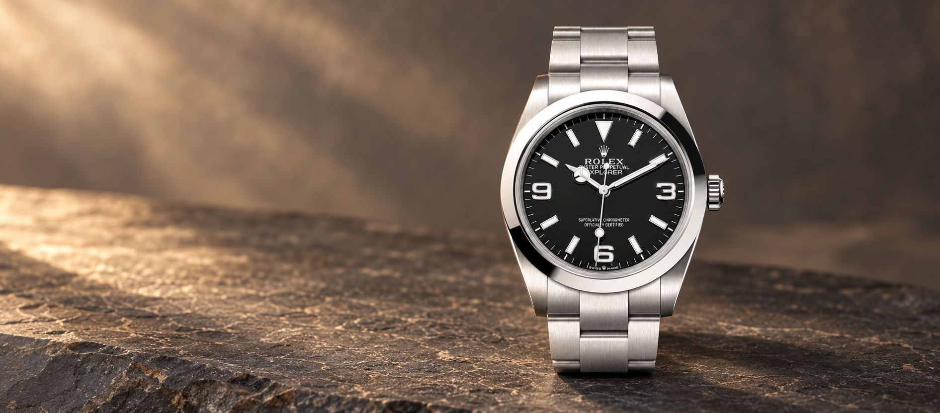 Rolex Explorer 40 reference 224270 with a black 3-6-9 dial and steel Oyster bracelet against a warm stone background