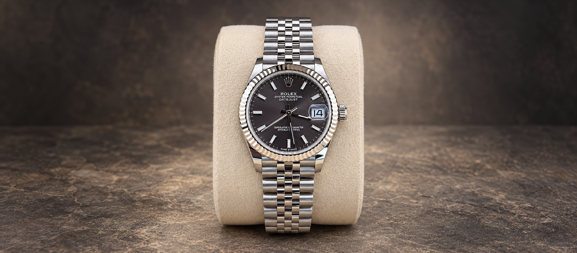 Rolex Datejust 31 reference 278274 with dark grey stick-marker dial, fluted bezel and Jubilee bracelet on a cream cushion