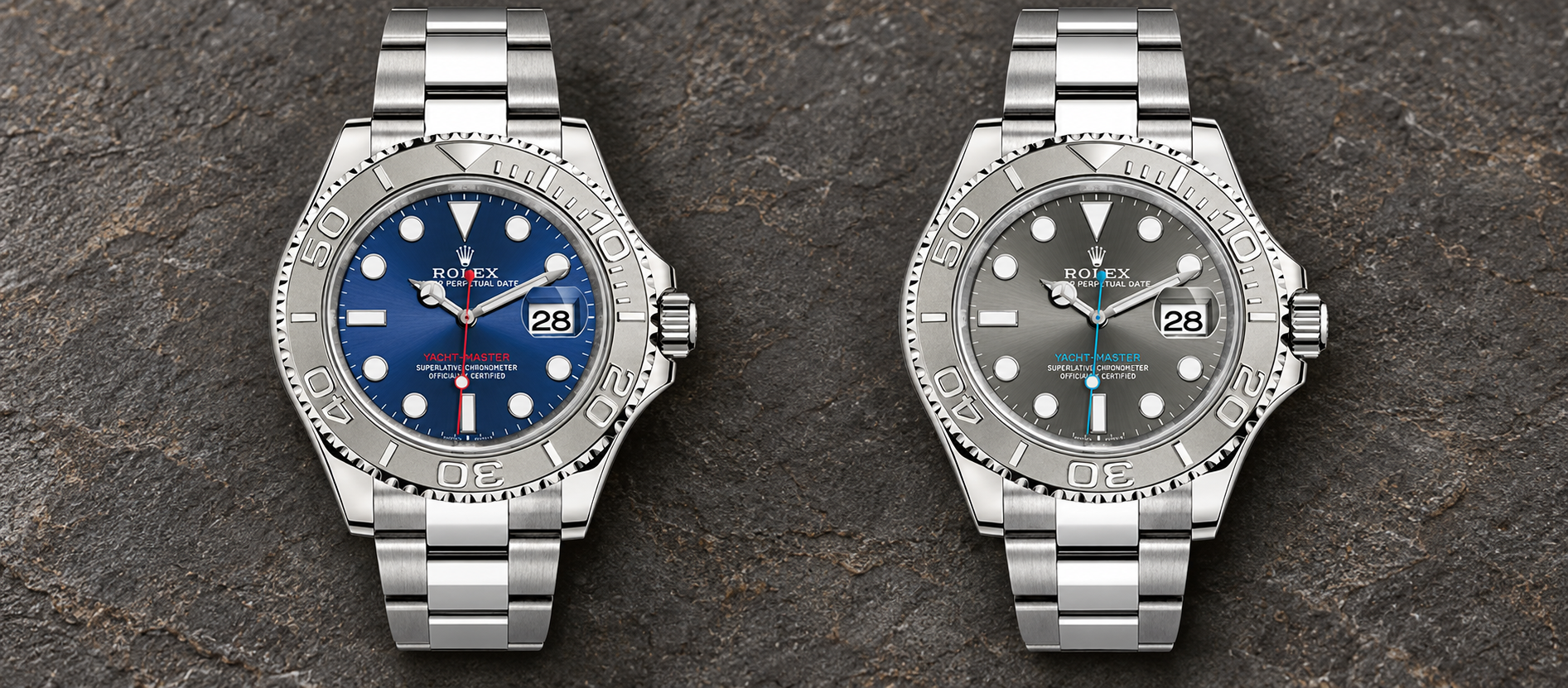 Rolex Yacht-Master 40 reference 126622 with blue dial at left and slate dial at right on a dark stone background